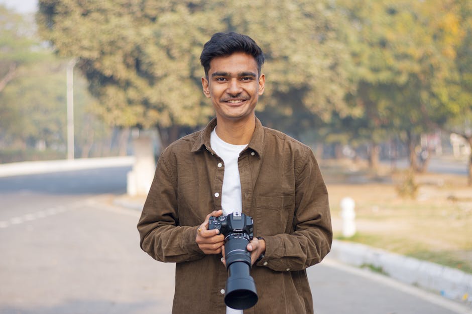 Professional wedding photographer holding a DSLR camera